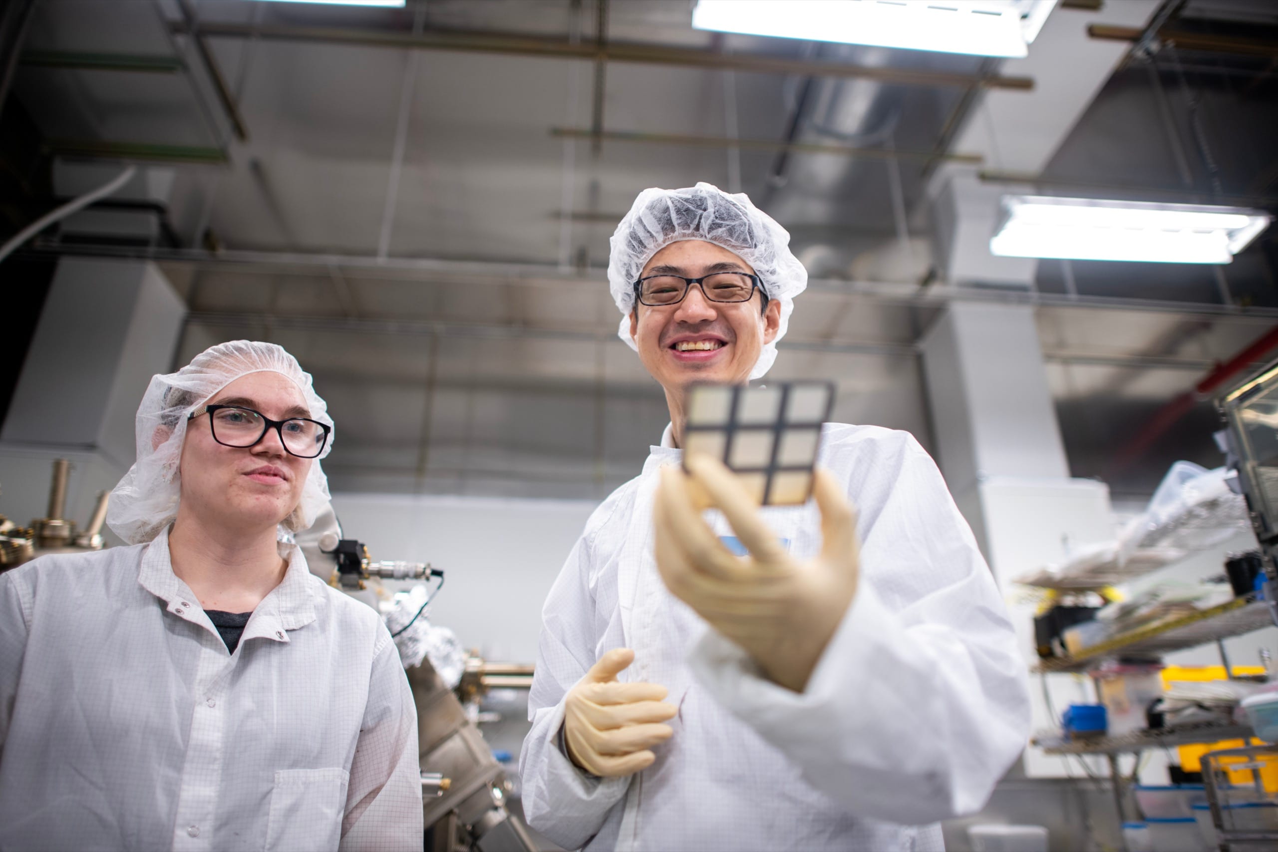 Two workers at technology factory