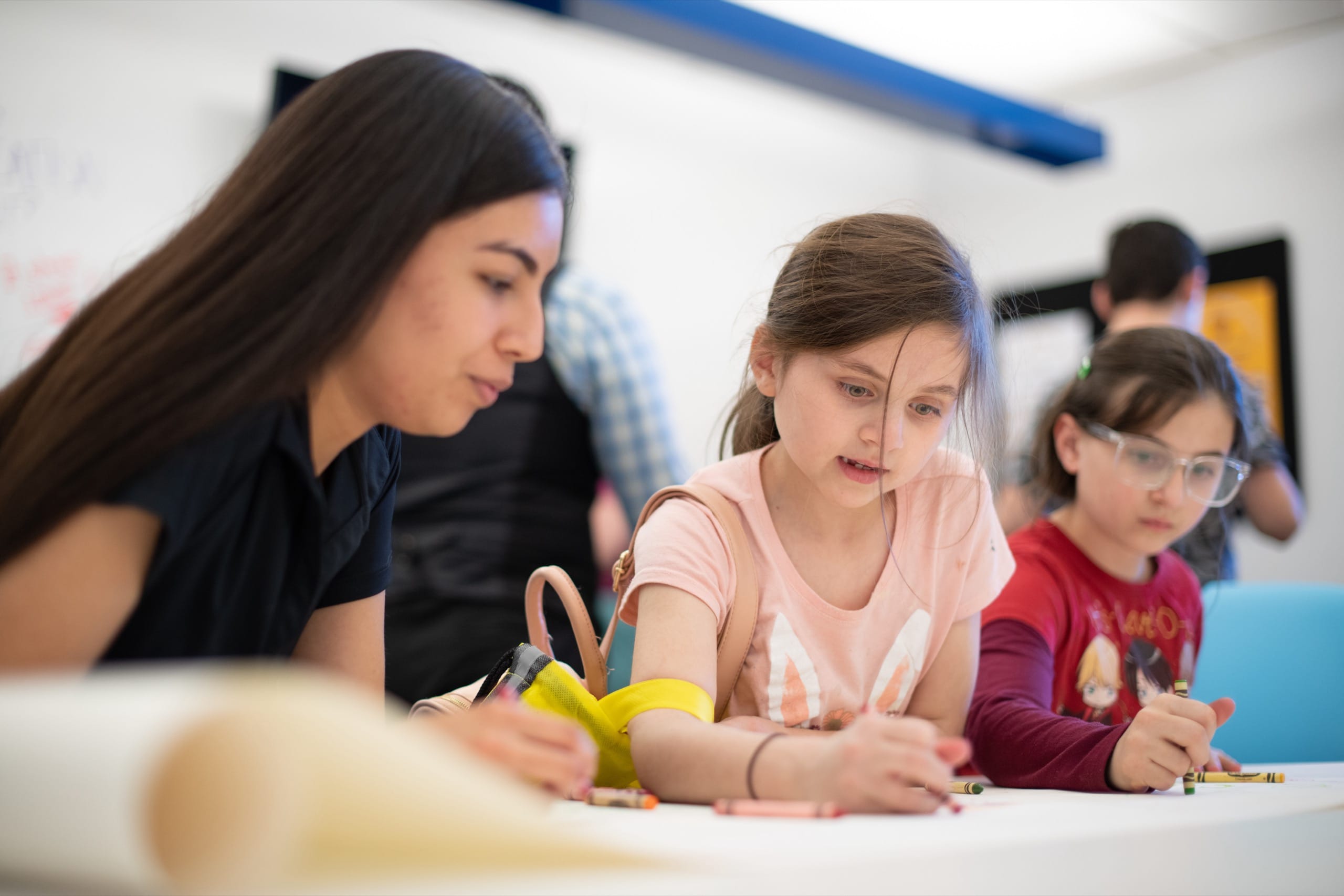 Woman drawing with two kids