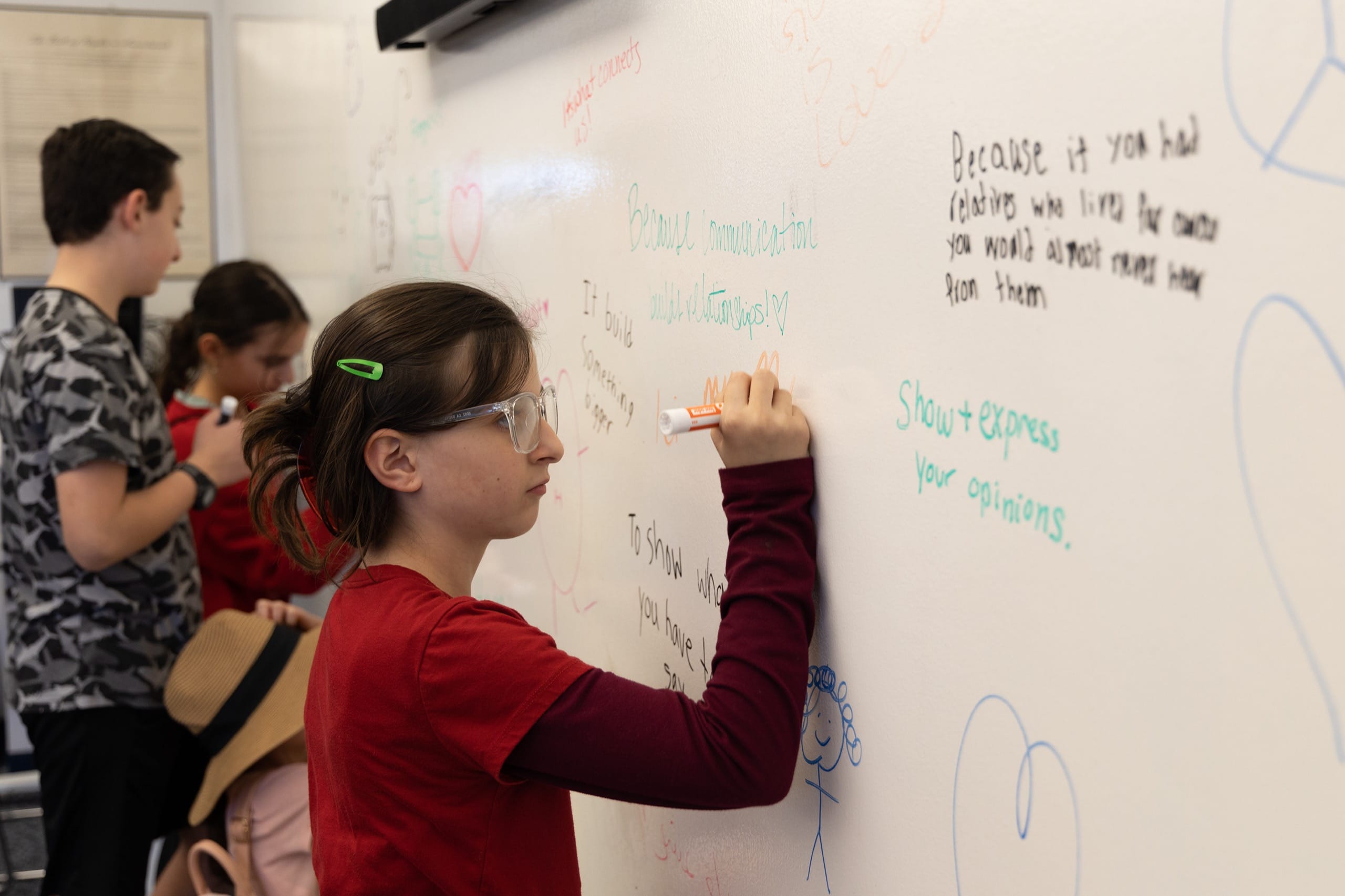 Student writing on whiteboard