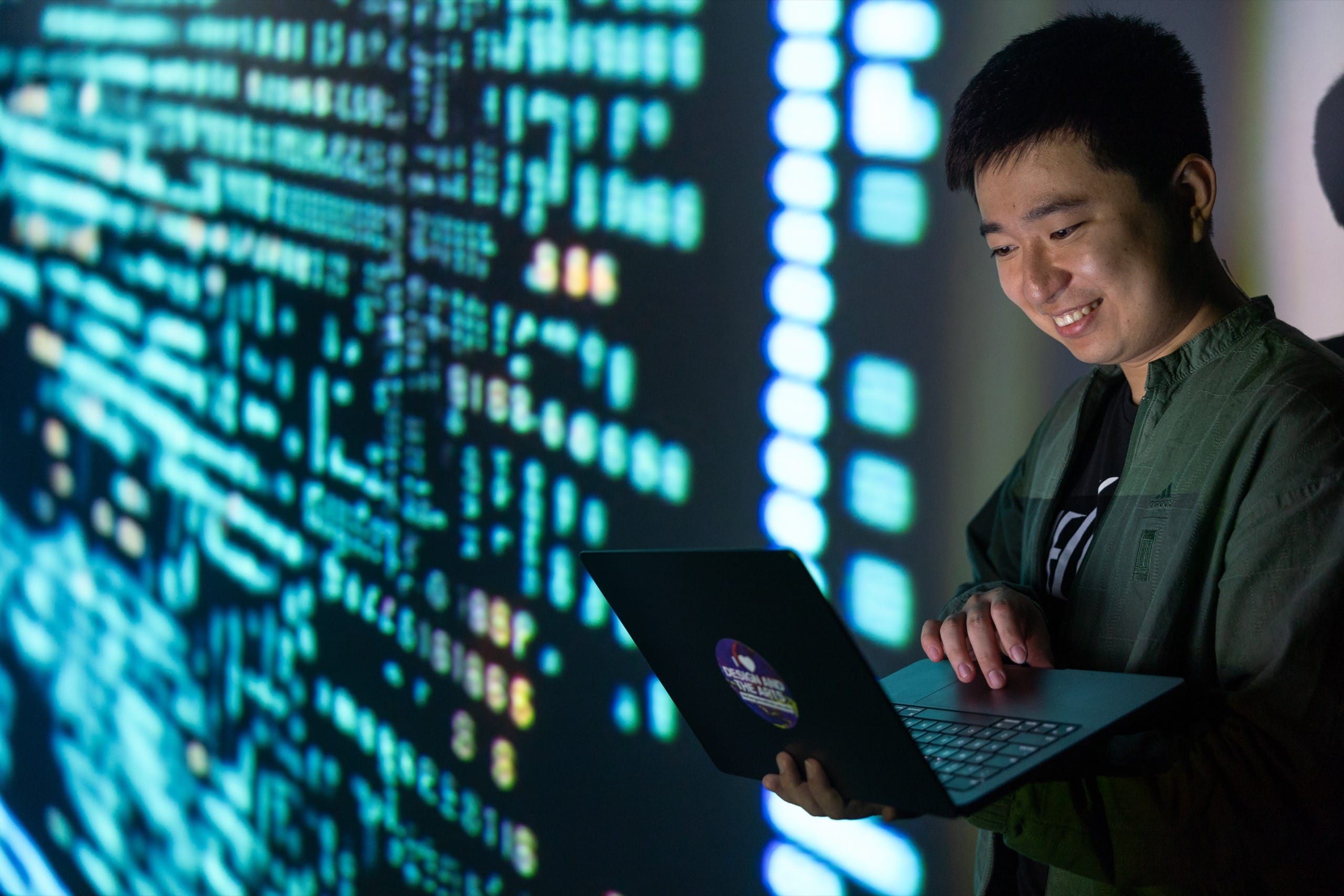 Man standing with laptop