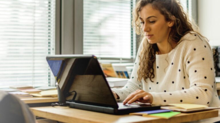 Women sitting at desk with laptop