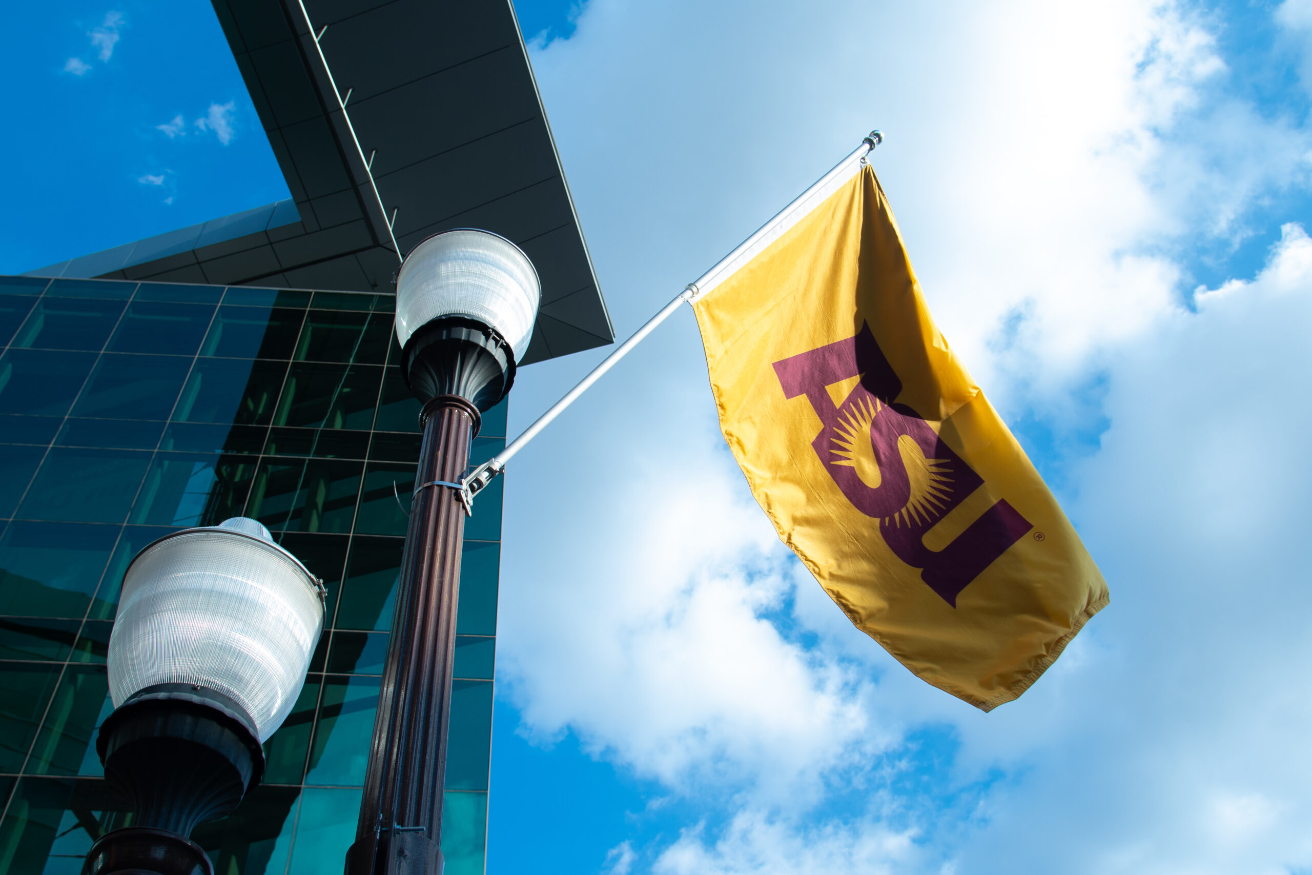 Gold and maroon ASU flag on a light pole