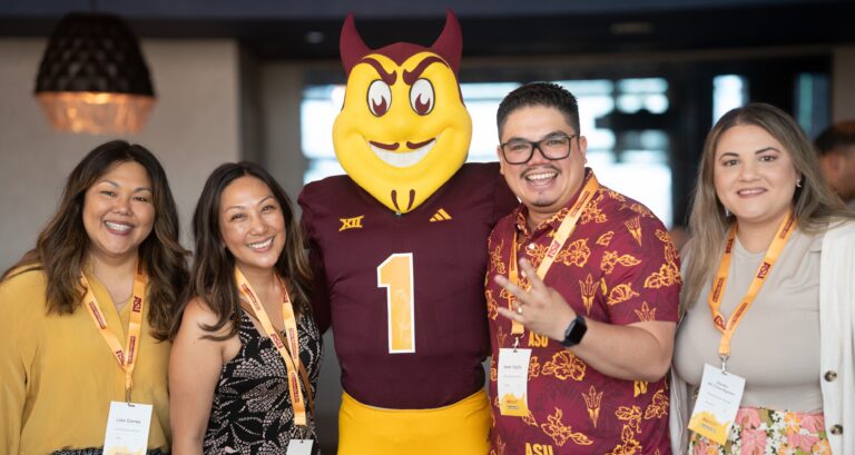 Four Accelerate ASU Partner Conference attendees smiling with ASU mascot Sparky Sun Devil