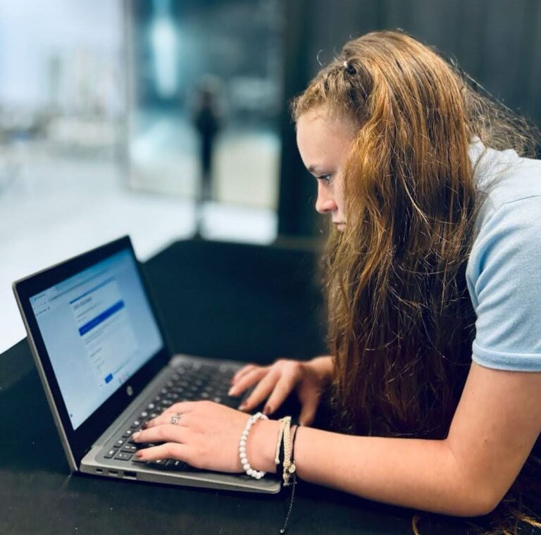 Student works at a laptop